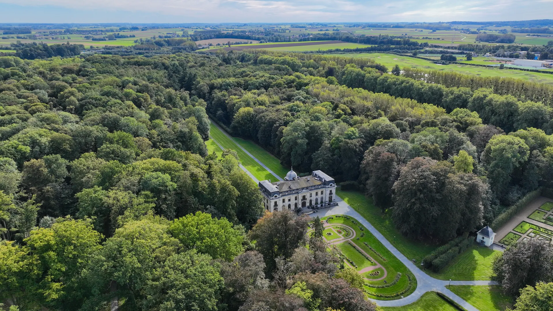 Aerial view of Château d'Enghien amid its wooded park