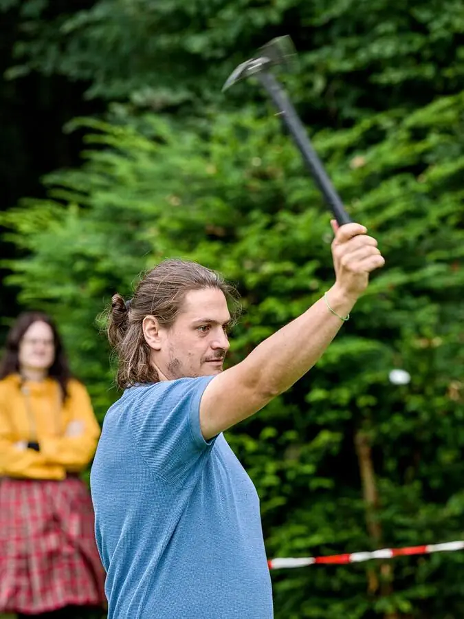 A participant throws an axe