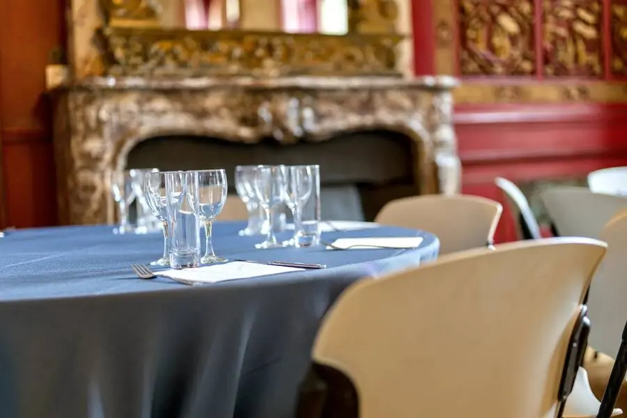 Table laid in front of a carved fireplace