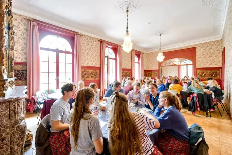 Participants seated in the red salon during lunch