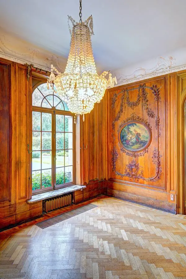 Crystal chandelier against the wood panelling of the reception room