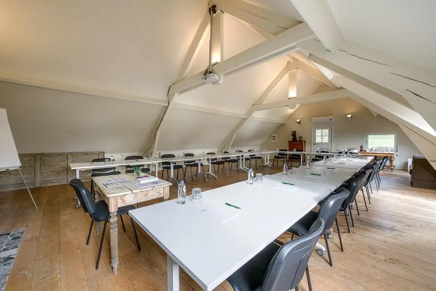 Bright meeting room with tables in rows