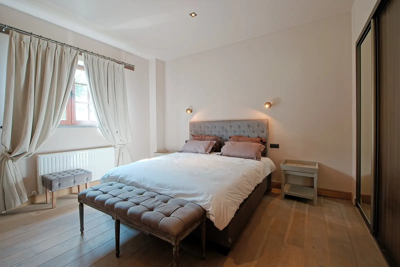 Double room with wooden headboard and white linen