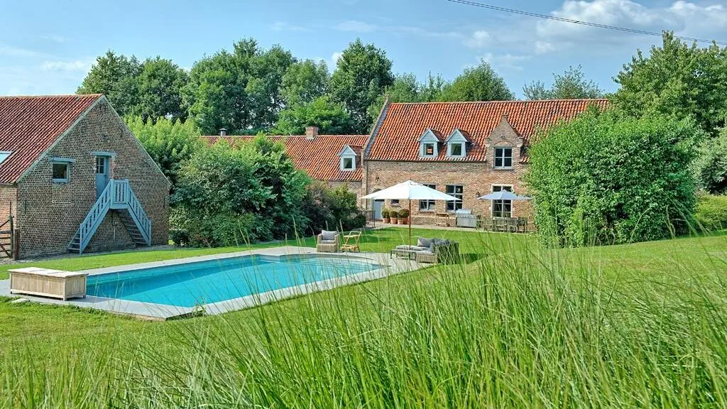 The buildings and pool surrounded by fields