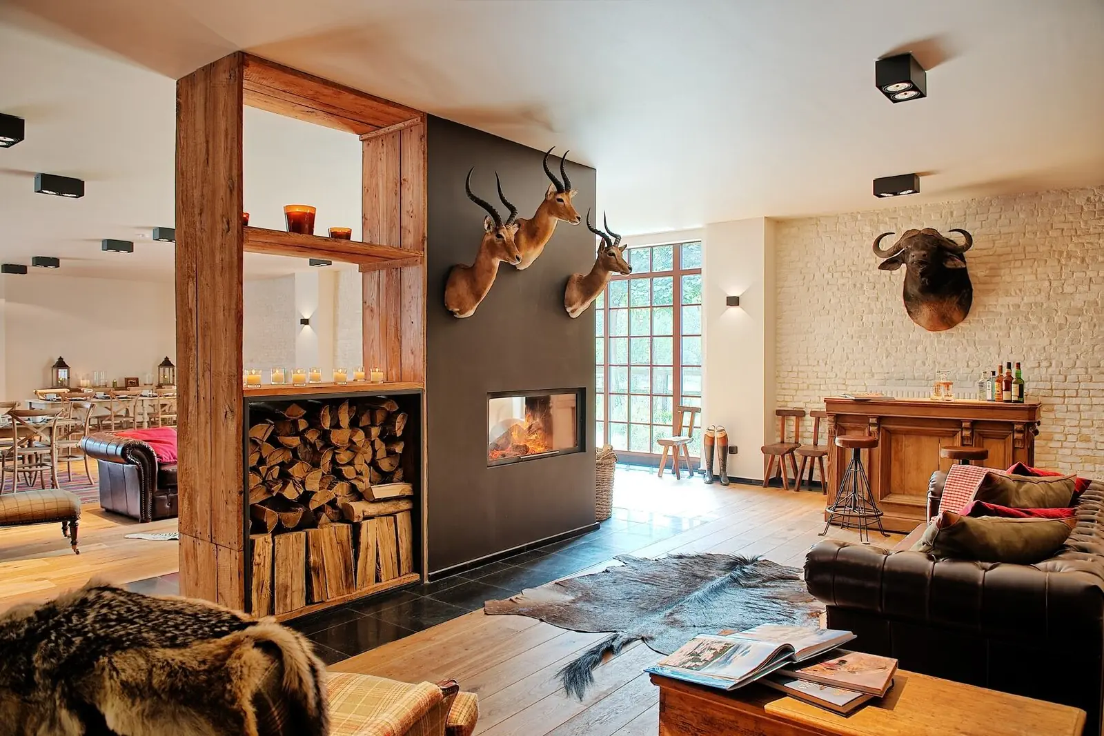 Lounge with fireplace, leather sofas and log store