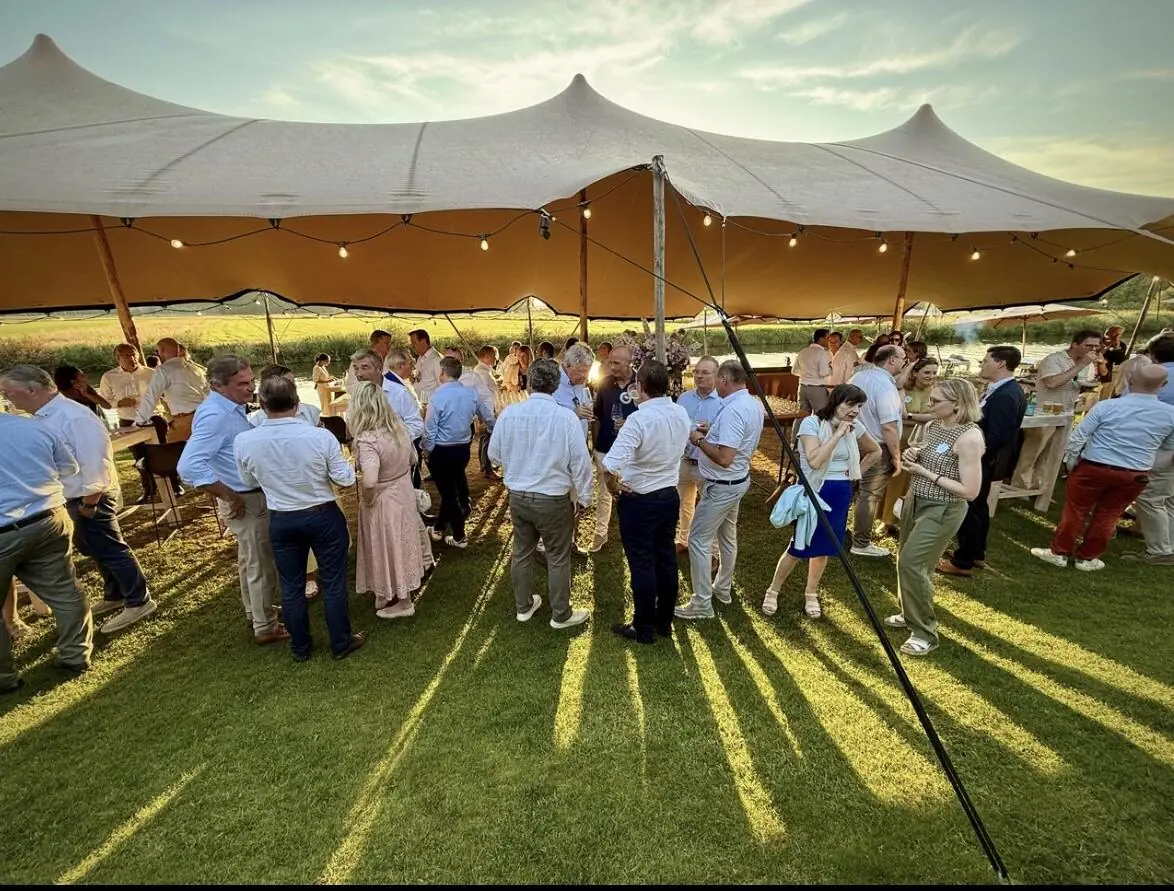 Reception under a large marquee at sunset