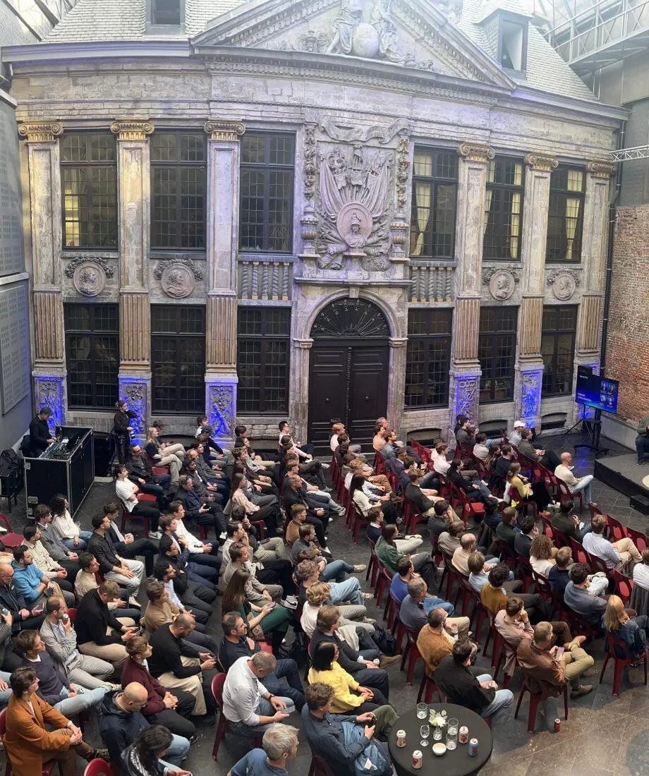 Conference in front of a historic façade under a glass roof