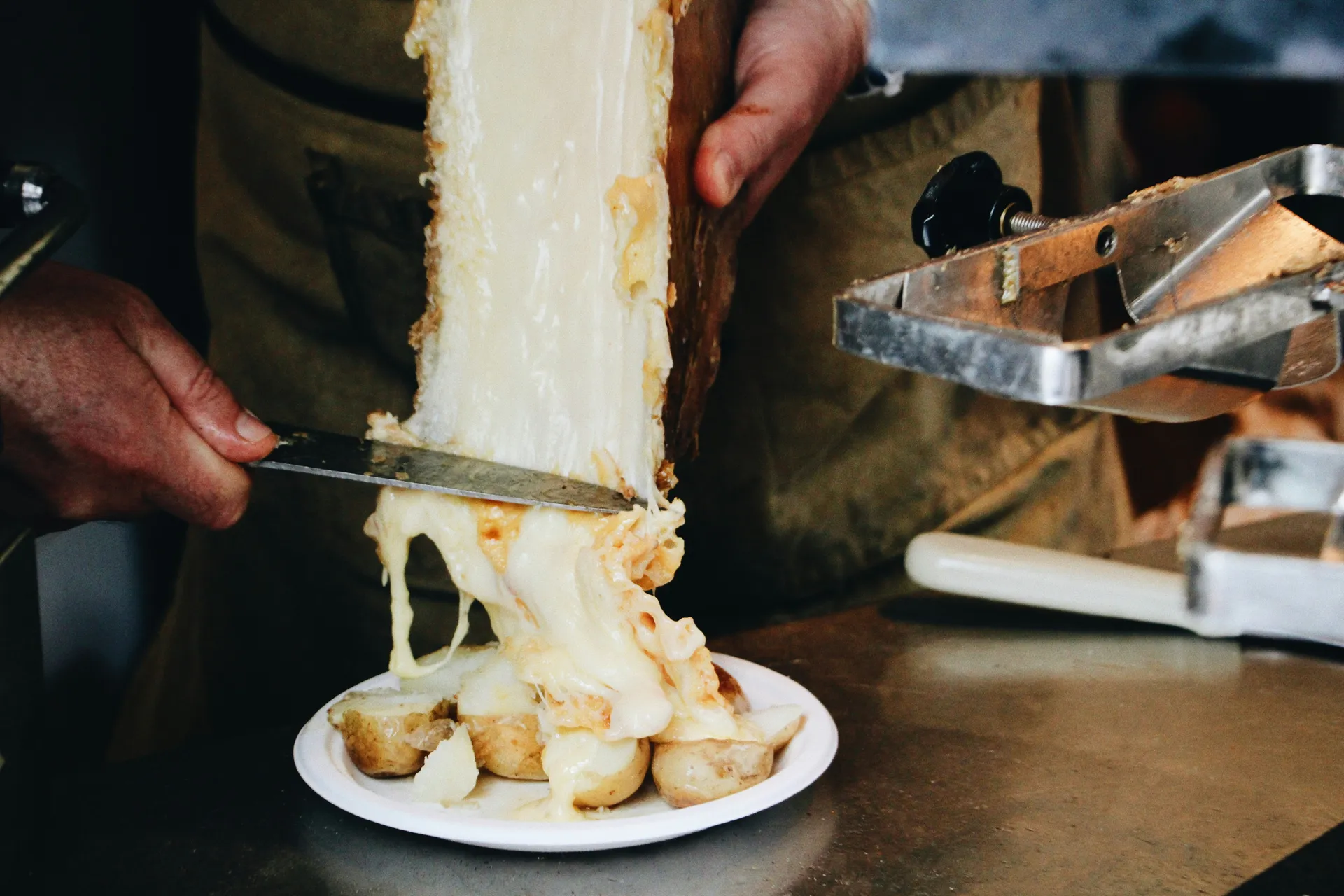 Raw-milk raclette scraped straight onto baby potatoes